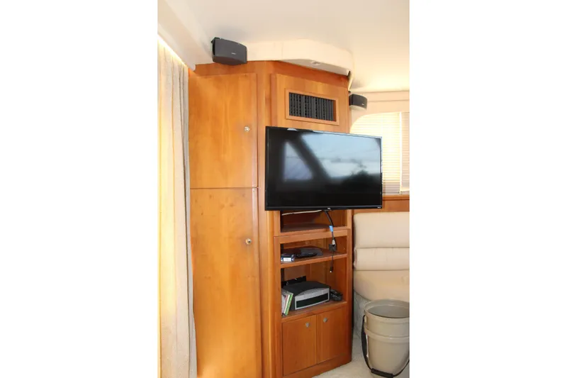 Slide: The Image of Interior of 2003 Silverton 38 Convertible yacht with TV and wooden cabinetry. - 56