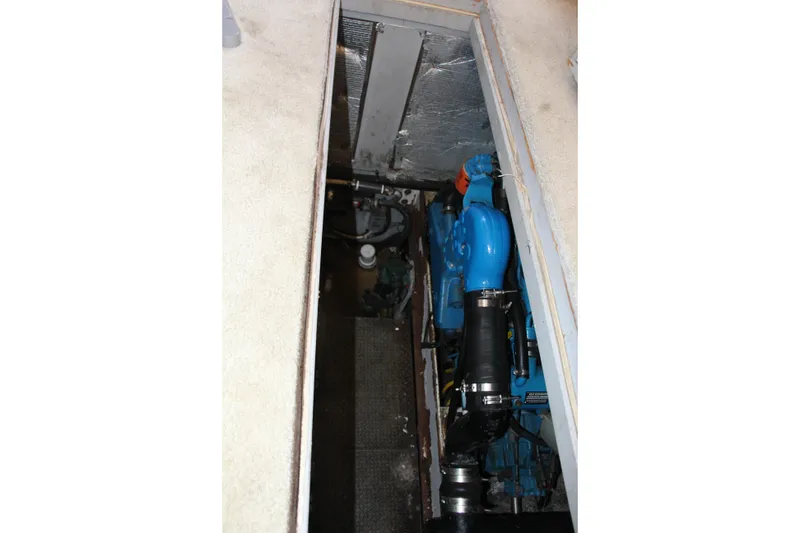 Slide: The Image of Engine compartment of a 2003 Silverton 38 Convertible boat, featuring a blue engine. - 58