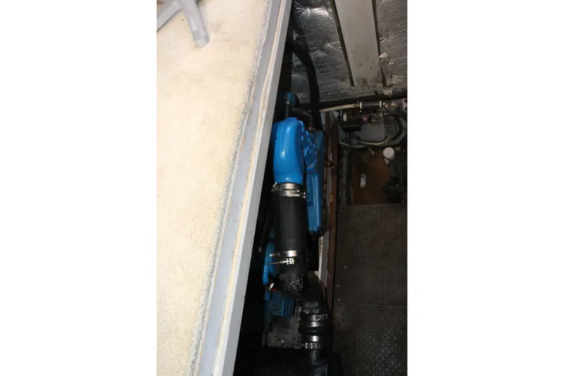 Slide: The Image of Engine compartment of a 2003 Silverton 38 Convertible boat, featuring blue engine components. - 59