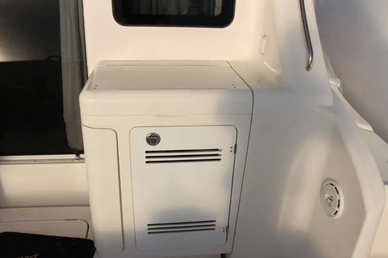 Slide: The Image of 2003 Silverton 38 Convertible yacht interior with storage compartment and speaker. - 60
