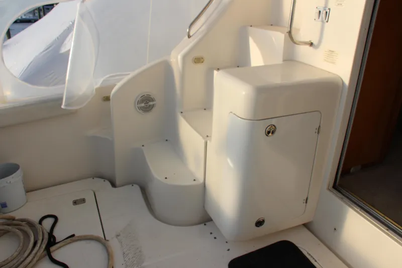 Slide: The Image of 2003 Silverton 38 Convertible yacht interior with white steps and storage compartment. - 62