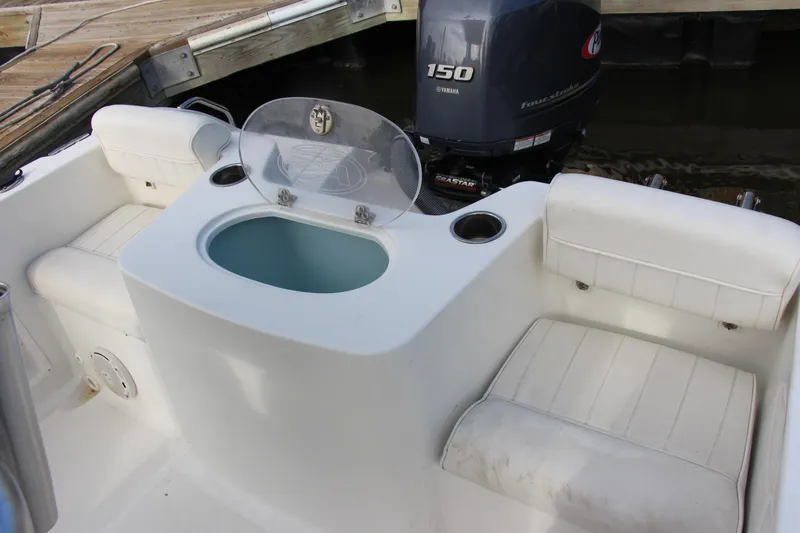 Slide: The Image of 2019 Sea Hunt Triton 210 boat interior with seating and Yamaha 150 outboard motor. - 20