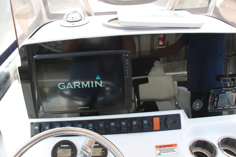 Slide: The Image of Dashboard of 2019 Sea Hunt Triton 210 with Garmin navigation system. - 24