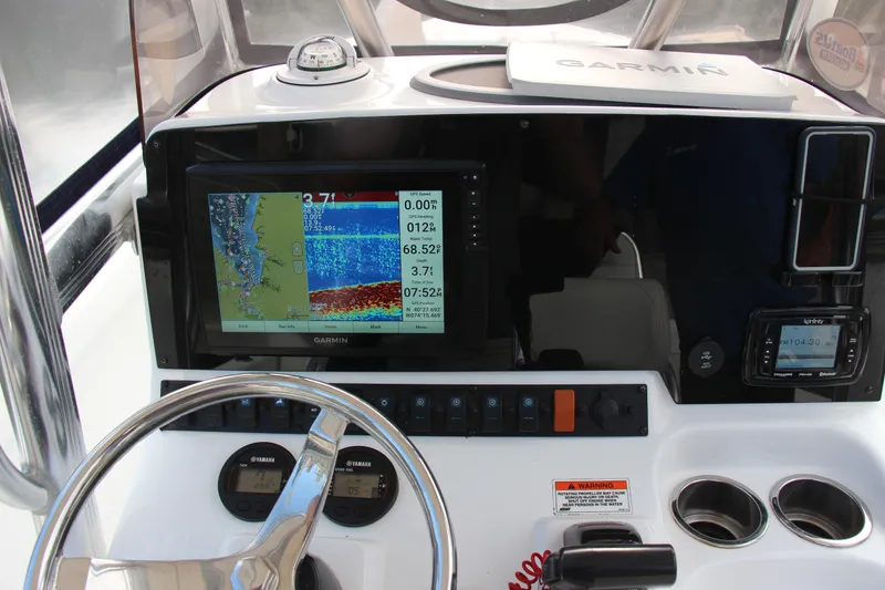 Slide: The Image of 2019 Sea Hunt Triton 210 dashboard with Garmin navigation system and steering wheel. - 26