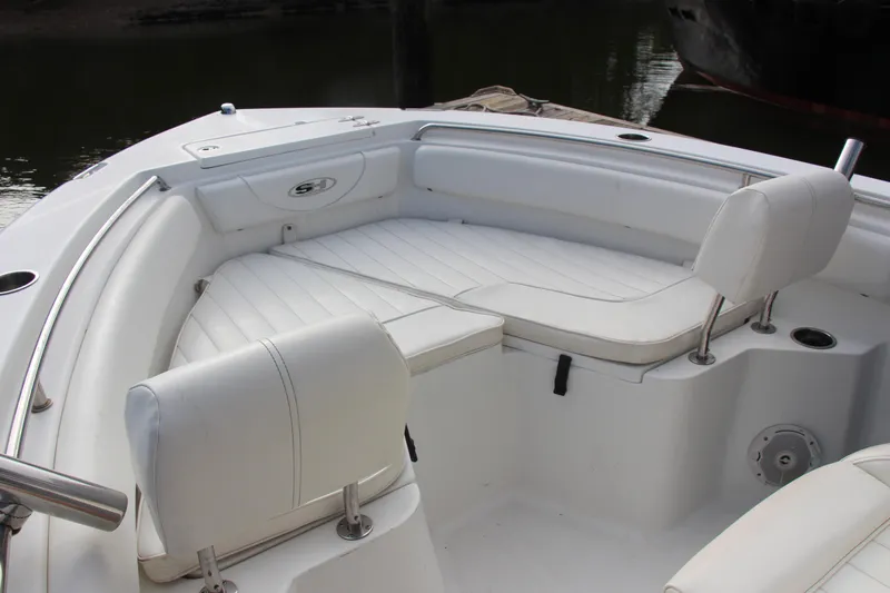 Slide: The Image of 2019 Sea Hunt Triton 210 boat interior with white cushioned seating. - 30