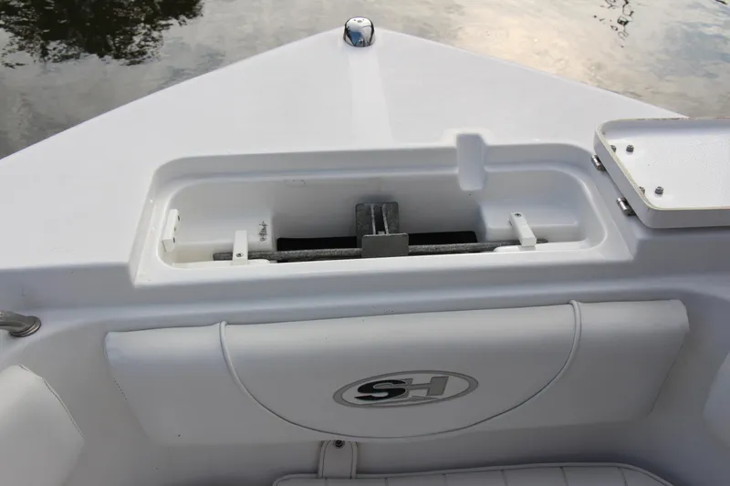 Slide: The Image of 2019 Sea Hunt Triton 210 boat anchor storage compartment with SH logo. - 31