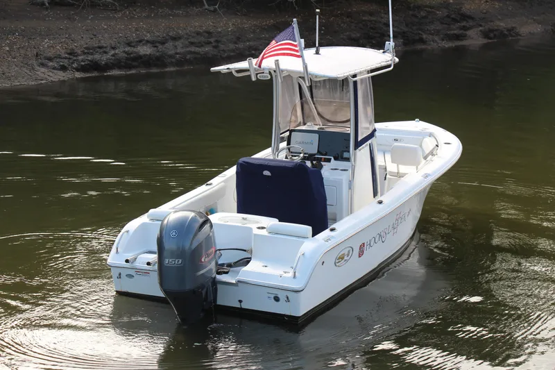 Slide: The Image of 2019 Sea Hunt Triton 210 boat with outboard motor on calm water. - 5