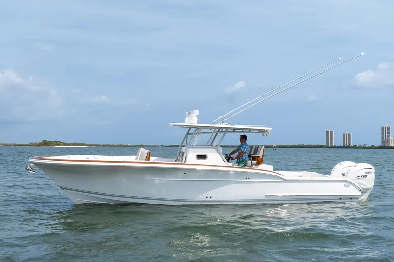 Slide: The Image of 2026 Buddy Davis 34 Center Console boat cruising on open water. - 11