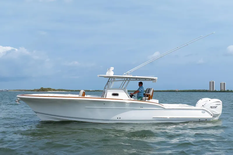 Slide: The Image of 2026 Buddy Davis 34 Center Console boat cruising on open water. - 12