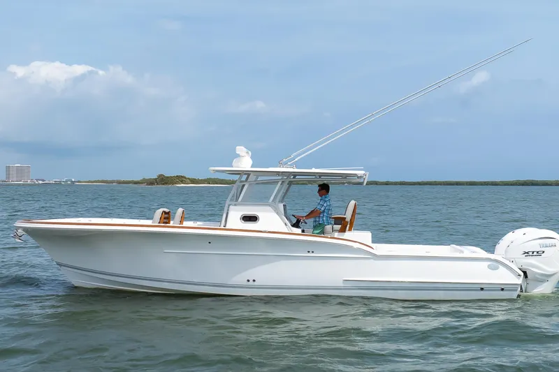 Slide: The Image of 2026 Buddy Davis 34 Center Console boat cruising on open water. - 13