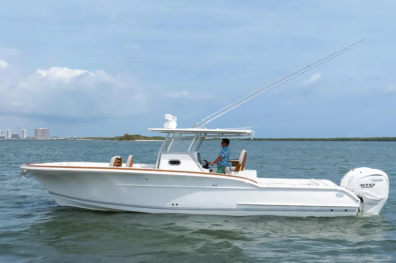 Slide: The Image of 2026 Buddy Davis 34 Center Console boat cruising on open water. - 14