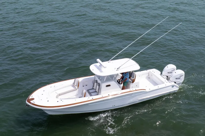 Slide: The Image of 2026 Buddy Davis 34 Center Console boat cruising on open water. - 15