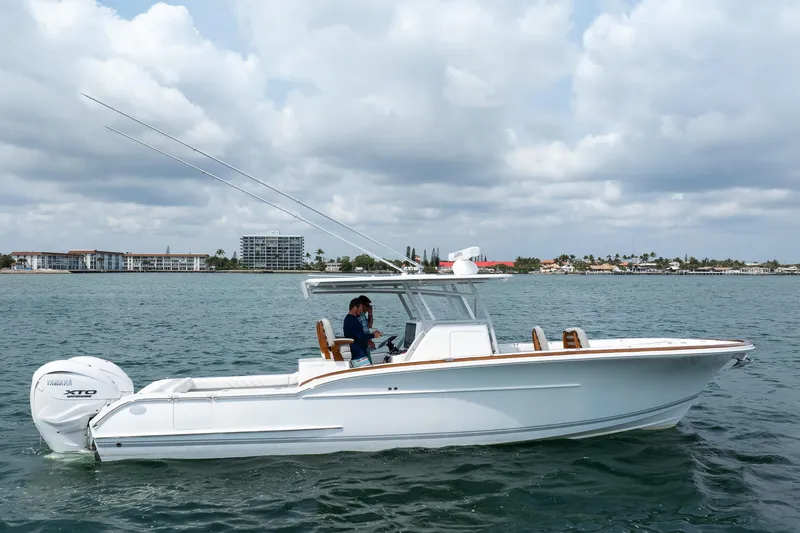 Slide: The Image of 2026 Buddy Davis 34 Center Console boat on water, featuring Yamaha XTO engine. - 22