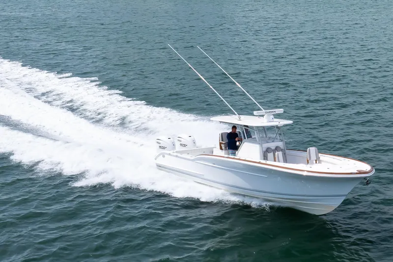Slide: The Image of 2026 Buddy Davis 34 Center Console boat cruising on open water. - 24