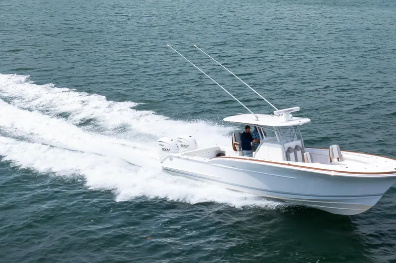 Slide: The Image of 2026 Buddy Davis 34 Center Console boat cruising on open water. - 26