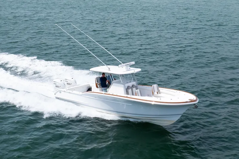Slide: The Image of 2026 Buddy Davis 34 Center Console boat cruising on open water. - 28