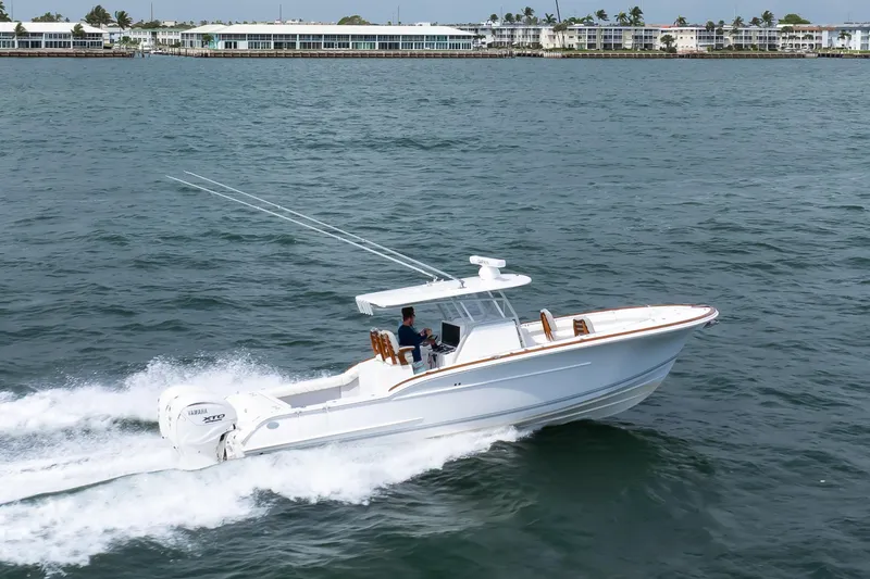 Slide: The Image of 2026 Buddy Davis 34 Center Console boat cruising on open water. - 30