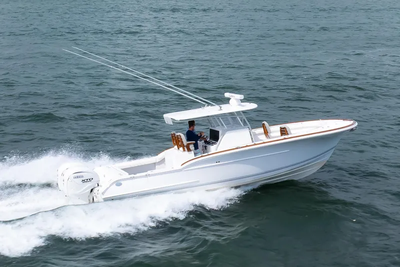 Slide: The Image of 2026 Buddy Davis 34 Center Console boat cruising on open water. - 31