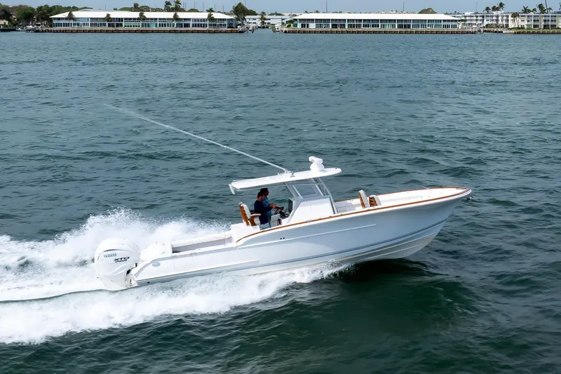 Slide: The Image of 2026 Buddy Davis 34 Center Console boat cruising on open water. - 32