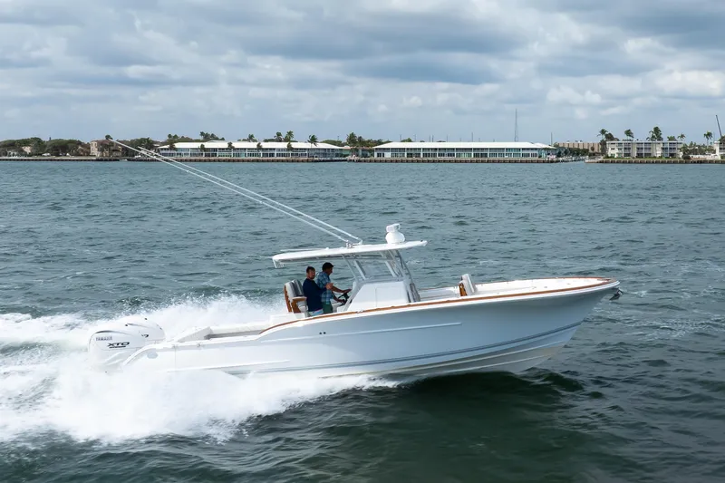 Slide: The Image of 2026 Buddy Davis 34 Center Console boat cruising on open water. - 34