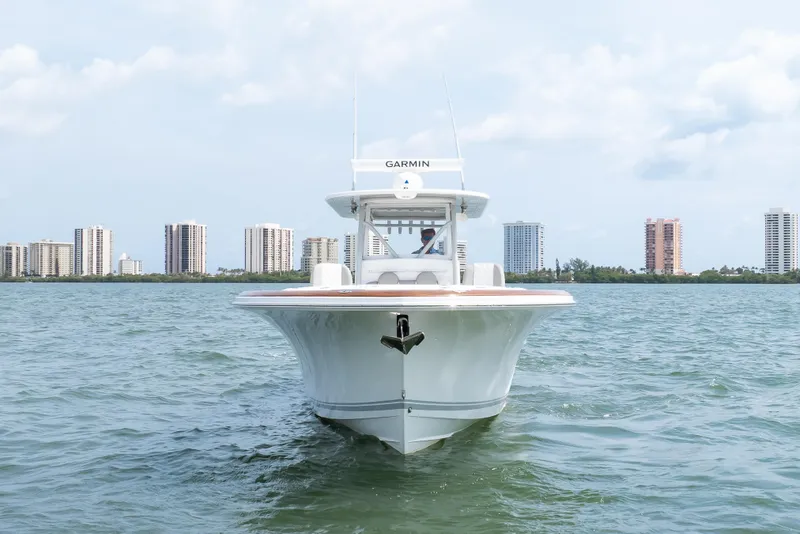 Slide: The Image of 2026 Buddy Davis 34 Center Console boat on water with city skyline background. - 4