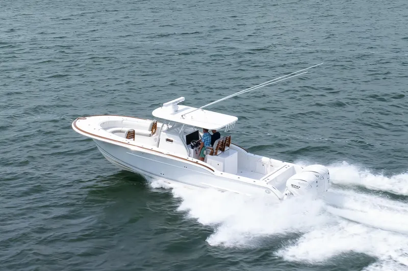 Slide: The Image of 2026 Buddy Davis 34 Center Console boat cruising on open water. - 46