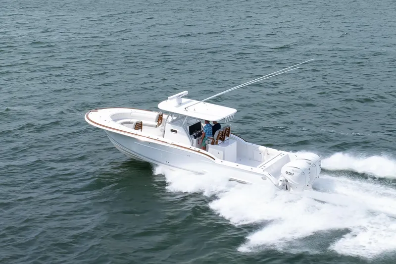 Slide: The Image of 2026 Buddy Davis 34 Center Console boat cruising on open water. - 47
