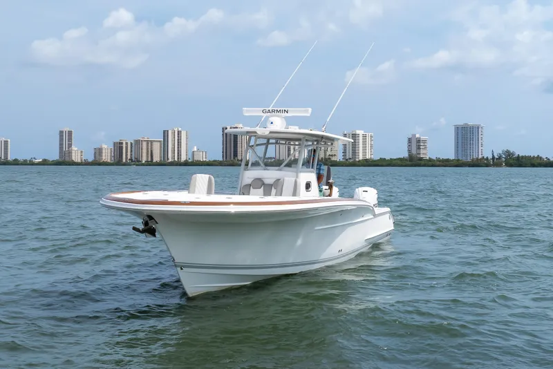 Slide: The Image of 2026 Buddy Davis 34 Center Console boat on water with city skyline background. - 5