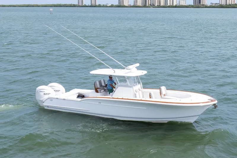 Slide: The Image of 2026 Buddy Davis 34 Center Console boat cruising on open water. - 54