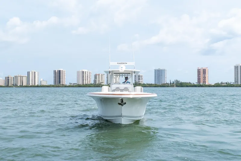 Slide: The Image of 2026 Buddy Davis 34 Center Console boat on water with city skyline background. - 55