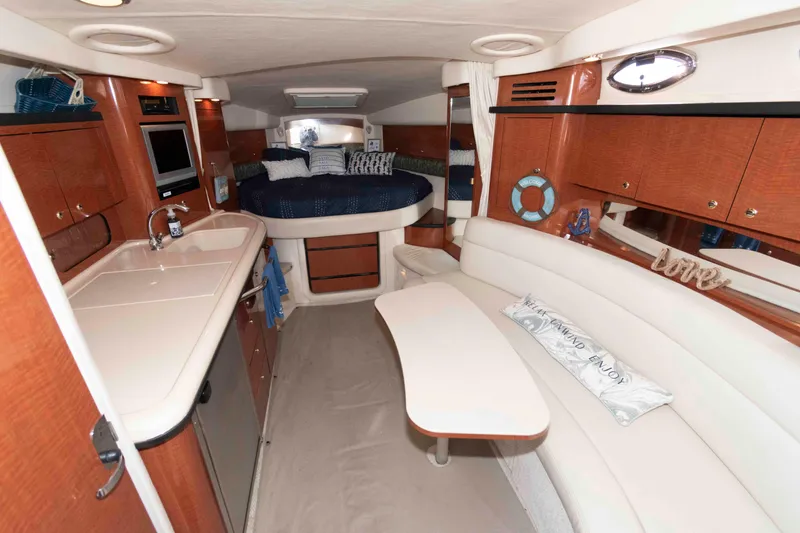 Slide: The Image of Interior of 2004 Sea Ray 340 Sundancer yacht with cozy seating and kitchenette. - 12