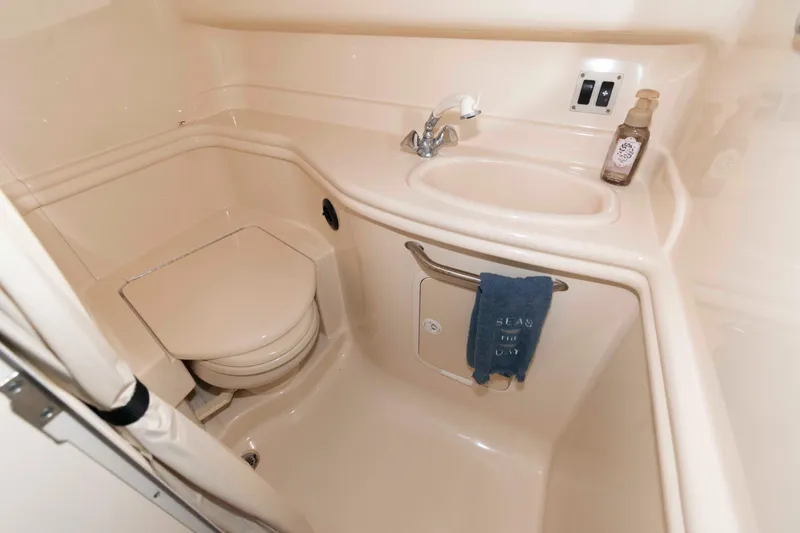 Slide: The Image of Bathroom interior of 2004 Sea Ray 340 Sundancer yacht, featuring sink and toilet. - 17
