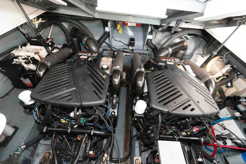 Slide: The Image of Engine room of 2004 Sea Ray 340 Sundancer with twin engines and mechanical components. - 18