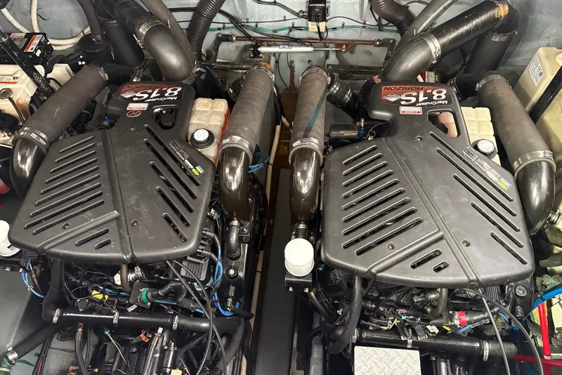 Slide: The Image of 2004 Sea Ray 340 Sundancer helm with white leather seats and modern controls. - 8