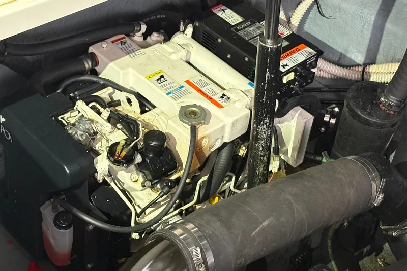 Slide: The Image of 2004 Sea Ray 340 Sundancer helm with navigation instruments and steering wheel. - 9