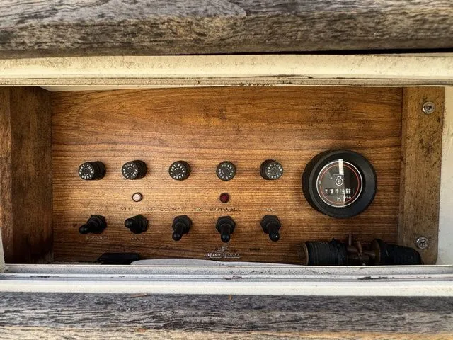 Slide: The Image of Control panel of a 1990 Mako 201 boat with gauges and switches. - 12