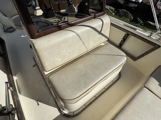 Slide: The Image of 1990 Mako 201 boat interior with beige seating and steering console. - 18