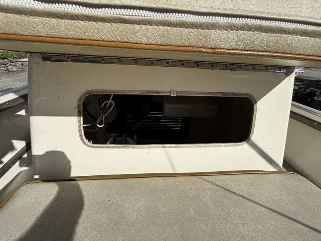 Slide: The Image of 1990 Mako 201 boat interior with open storage compartment and visible wiring. - 20