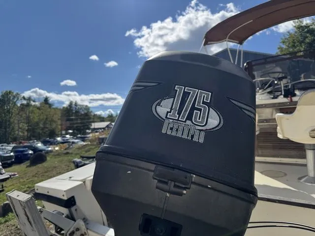 Slide: The Image of Outboard motor on a 1990 Mako 201 boat under a sunny sky. - 4
