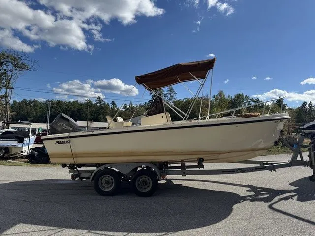 Slide: The Image of 1990 Mako 201 boat on trailer under blue sky with clouds. - 6