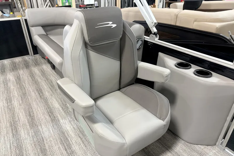 Slide: The Image of Captain's chair in 2025 Bennington SSR boat, featuring gray upholstery and armrests. - 8