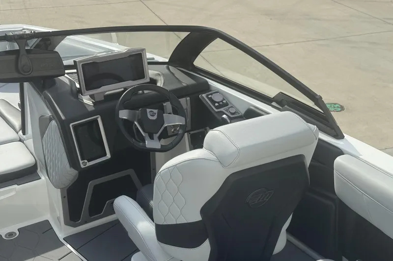 Slide: The Image of 2023 Malibu M220 boat interior with modern dashboard and steering wheel design. - 4