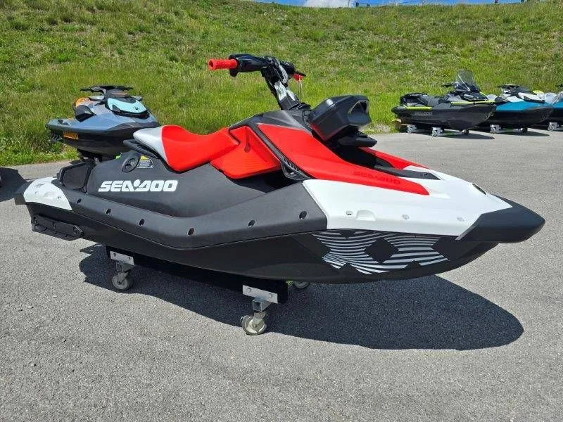 Slide: The Image of 2026 Sea-Doo Spark Trixx on pavement with green background. - 18