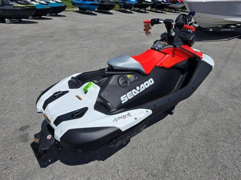 Slide: The Image of 2026 Sea-Doo Spark Trixx jet ski displayed in parking lot. - 20