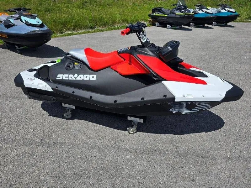 Slide: The Image of 2026 Sea-Doo Spark Trixx jet ski parked on asphalt. - 21