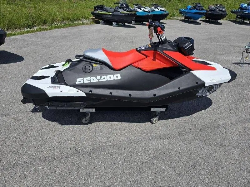Slide: The Image of 2026 Sea-Doo Spark Trixx jet ski parked on pavement. - 22