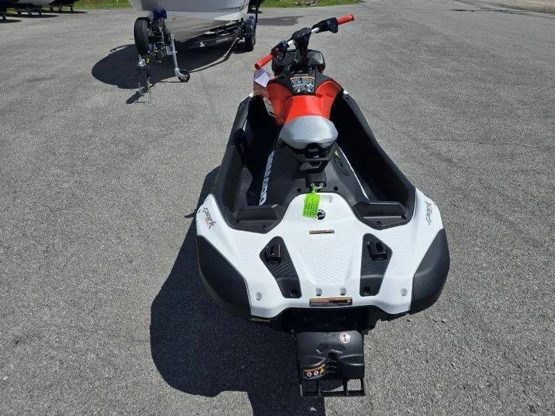 Slide: The Image of 2026 Sea-Doo Spark Trixx jet ski parked on asphalt. - 23