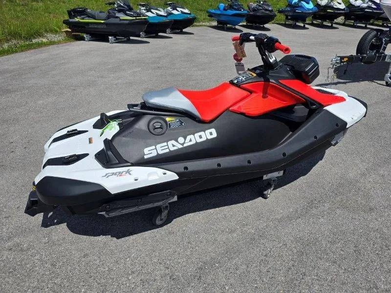 Slide: The Image of 2026 Sea-Doo Spark Trixx jet ski parked on asphalt. - 24