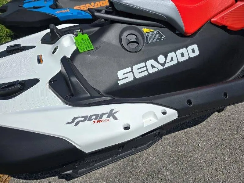 Slide: The Image of 2026 Sea-Doo Spark Trixx jet ski parked on asphalt. - 26