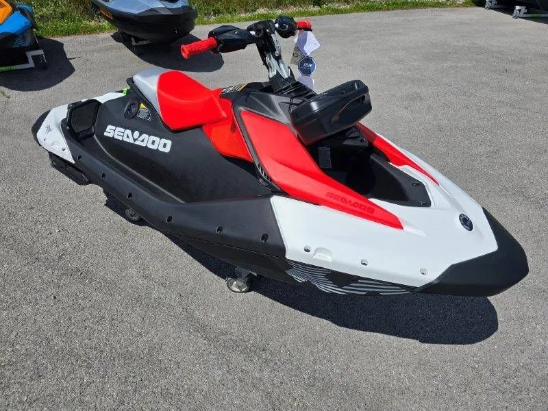 Slide: The Image of 2026 Sea-Doo Spark Trixx jet ski in black and red on pavement. - 28